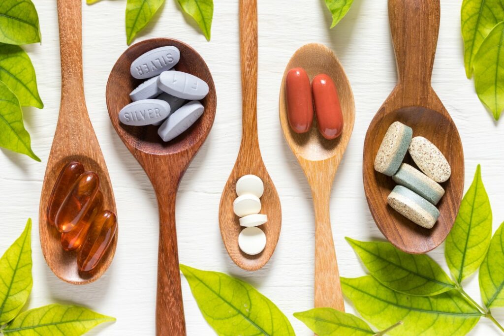 Vitamins on wooden spoon